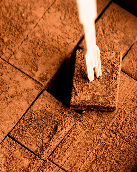 Close-up of a cocoa-dusted Ganache de Luxe square on a fork
