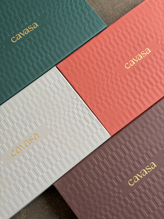 Cavasa Ganache de Luxe boxes in green, coral, ivory and brown textured sleeves